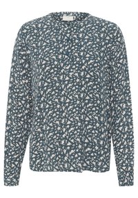 Blouse à manches longues en tissu vert foncé avec un motif abstrait blanc. Présente un col rond et des détails de boutons à l'avant.