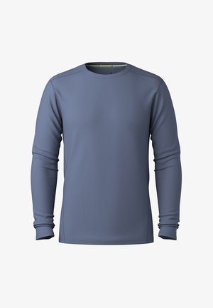 Pitkähihaisen paidan väri on liuskekivi sininen ja siinä on sileä rakenne. Paidassa on pyöreä kaula-aukko ja hienovaraiset ompeluyksityiskohdat hihoissa.