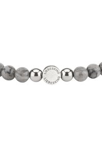 Bracciale in pietra di marmo grigia con accenti in metallo tono argento e una perlina rotonda con il marchio "LIEBESKIND" inciso. Texture liscia, forma arrotondata.