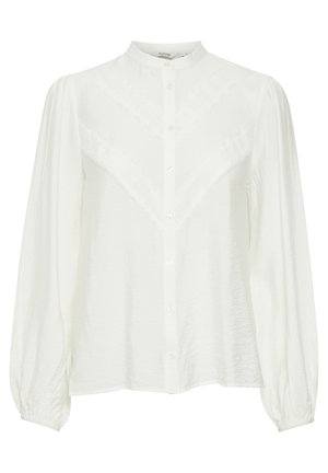 Fehér ing, mandarin gallérral, textúrált V-mintával az anyagon, hosszú, puffos ujjakkal és rugalmas mandzsettákkal.