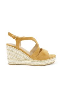 Wedge sandal in mustard yellow suede with adjustable strap, open toe, and jute sole featuring woven texture and contrasting gold accents.