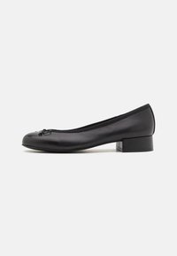 Black leather ballet flats with a small rectangular heel, rounded toe, decorative bow detail, and elastic trim at the opening.