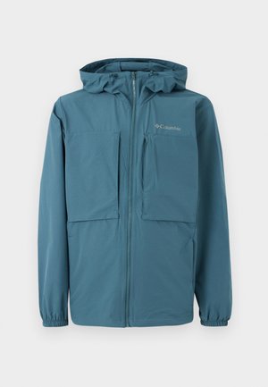 Blå Columbia-jakke med hætte, fuld lynlås foran, elastiske manchetter og flere forlommer på hvid baggrund.