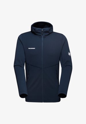 Giacca softshell blu navy con zip completa, collo alto, tasche laterali e logo Mammut; texture liscia e design aderente.