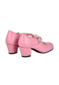 Zapatos de cuero rosa con puntera redonda, tacón pequeño y cierre decorativo de hebilla. Textura suave con detalles de costura en contraste.