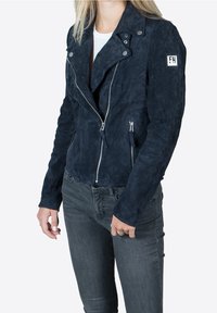 Navy suede motorcycle jacket with zippered front, silver hardware, and pointed collar. Features fitted design and side pockets.