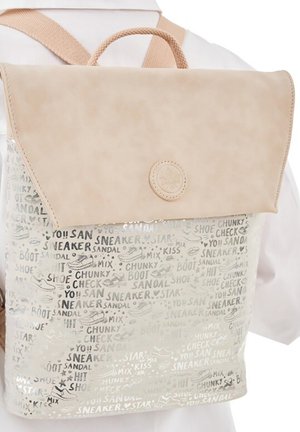 Beige backpack with flap closure, printed with words like "sneaker," "sandal," and shoe illustrations in gray and white tones.