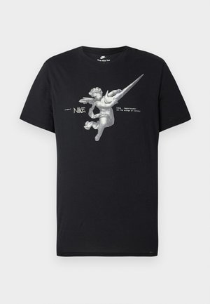 Black Nike T-shirt featuring a grayscale winged angel graphic with an elongated Nike swoosh and text "nike sportswear on the wings of victory."