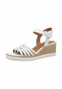Bílé kožené sandály na wedge s tkanou jutu platformou. Obsahují otevřenou špičku, design křížových popruhů a nastavitelné zápěstní popruhy.