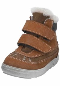 Scarpa in pelle marrone con due cinturini in Velcro regolabili, morbida fodera in pelliccia, punta arrotondata e dettagli di cucitura bianca sulla parte superiore e sulla suola.