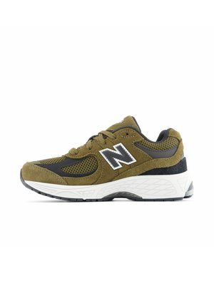 Athletic shoes in olive green suede with black mesh accents, white midsole, and textured rubber outsole. Silver logo on the side.