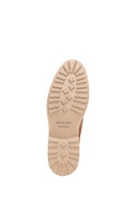 Suola in gomma beige di una scarpa con un motivo a rilievo, con un logo che recita "WITTCHEN handmade". Il design è semplice e robusto.