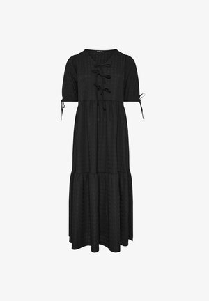 Zwarte maxi-jurk met een gelaagd ontwerp, korte mouwen en een vetersluiting aan de voorkant. Gemaakt van gestructureerde stof met strikjes op de mouwen.
