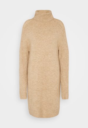 Bēšas krāsas augstā apkakle, mīksta adījuma tekstūra, brīva piegriezuma, garas piedurknes un nedaudz pārāk liels dizains.