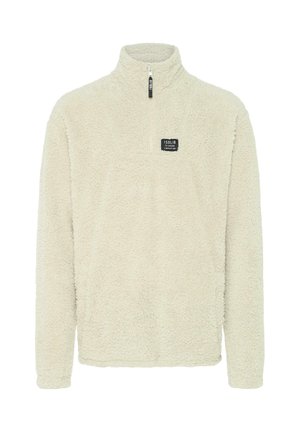 Kreemjas fleece-pullover kõrge kaelusega, osalise luku ja väikese ruudukujulise logoaplikatsiooniga rinnal; omab pehmet, tekstuurset pinda.