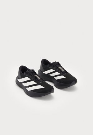 Black athletic shoes with white three-stripe design, sporty silhouette, textured mesh upper, and padded collar for comfort.