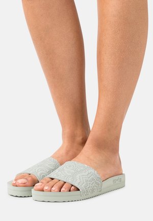 Light green slide sandals with a textured floral pattern on the strap and a patterned rubber sole. Lightweight and open-toe design.