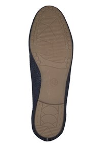 Black sneaker sole made of rubber with a textured pattern. Features pronounced grooves, "SOFT FLEX" text, and a rounded edge design.