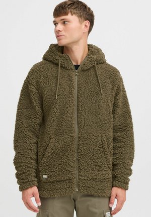 Olive green fleece hoodie with a zip closure, large hood, front pockets, and textured, fluffy surface. Features adjustable drawstrings.