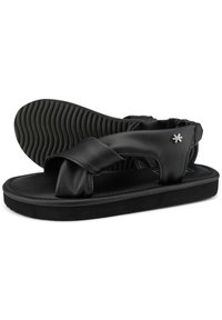 Black sandals made of smooth leather, featuring a wide cross-strap design, textured black rubber sole, and small silver logo accent.