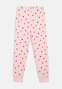 Light pink pants made of soft fabric, featuring a scattered red heart pattern. Elastic waistband and tapered cuffs at the ankles.