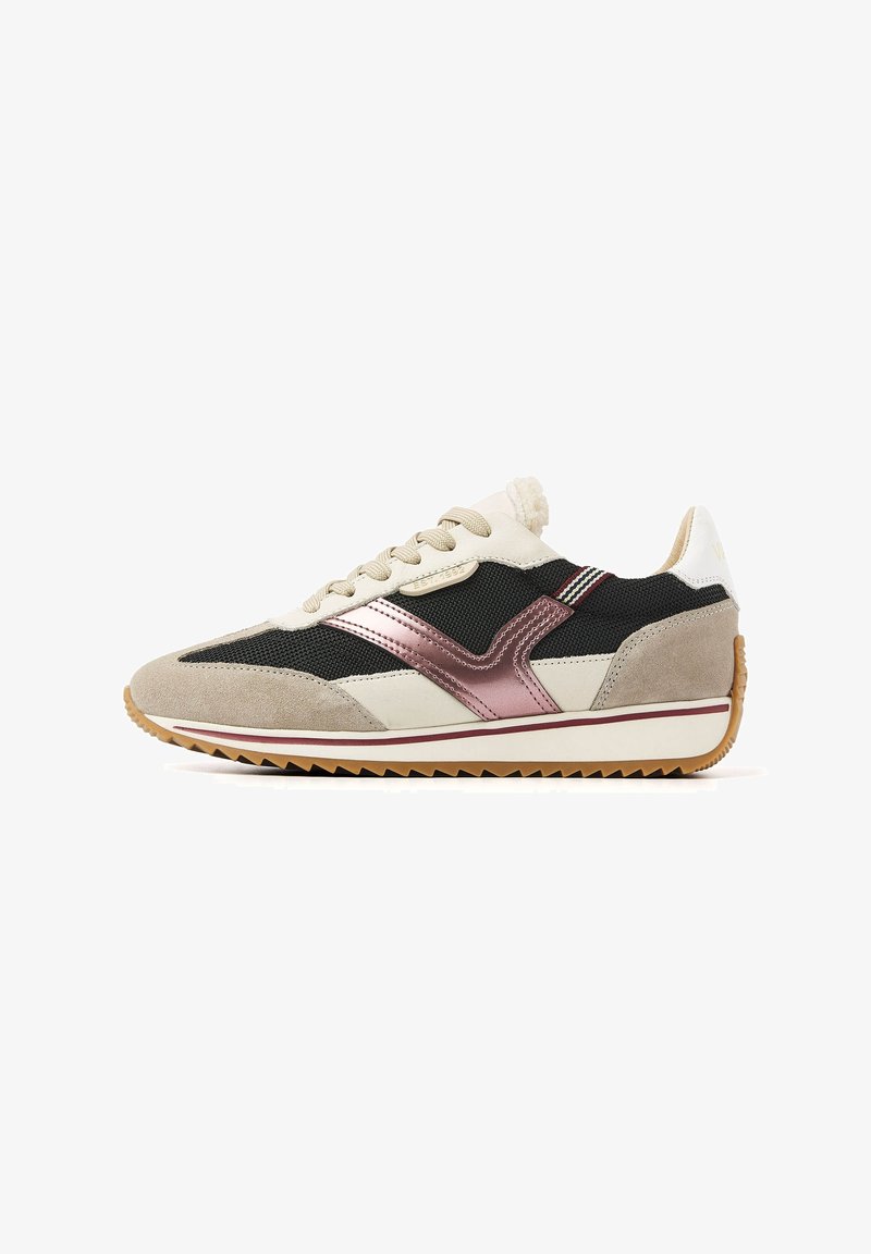 Tan and black sneakers featuring a suede and mesh upper, metallic accents, textured rubber sole, and a layered design with contrasting colors.