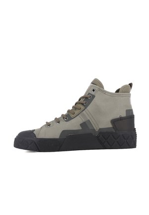 High-top sneaker with beige fabric upper, black rubber sole with textured grip, metal eyelets, and pull tab at heel.