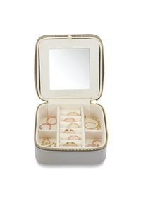 Jewelry box with zip closure, cream exterior, soft inner lining, mirror, and multiple compartments for rings in various gold and rose gold tones.