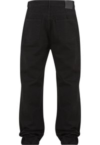 Vaqueros negros de pierna recta mostrados desde atrás con dos bolsillos traseros y una etiqueta en la cinturilla en el lado derecho.