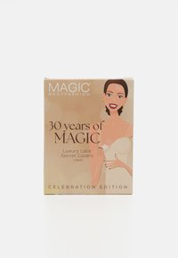 Magic Bodyfashion celebration edition box contains luxury lace secret covers, featuring a beige background and a smiling illustrated woman.