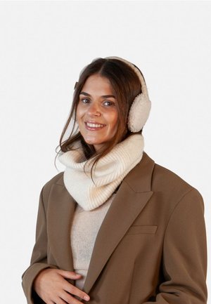 Fleece-lined earmuffs and a ribbed knit cream scarf worn under a brown blazer. The scarf is oversized, providing warmth and comfort.