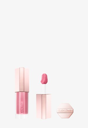 Rouge à lèvres liquide rose avec capuchon en or rose, applicateur montrant la couleur rose, et capuchon en or rose séparé avec le nom de la marque Lancôme.