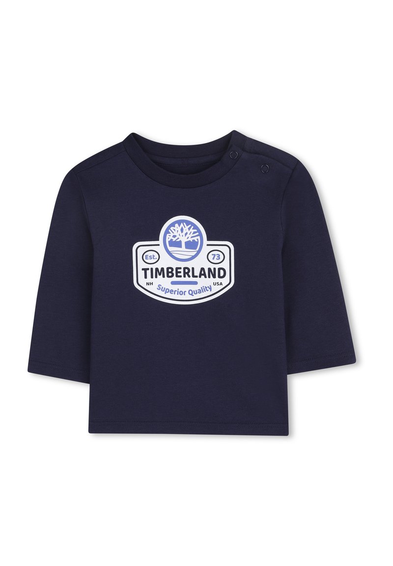 Granatowa koszulka z długim rękawem z bawełny, z białym logo Timberland i grafiką drzewa, z dwoma zatrzaskami na ramieniu.