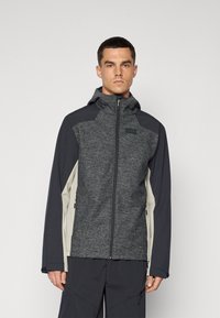 Gray and dark blue hooded jacket with a textured body, smooth sleeves, zippered pockets, and a fitted design. Measures medium size.