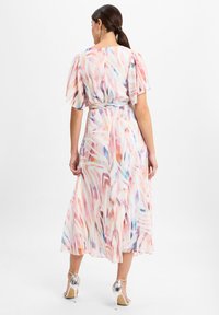 Flowy, pastel-colored midi dress with a watercolor pattern, short flutter sleeves, and a cinched waist, made from lightweight fabric.