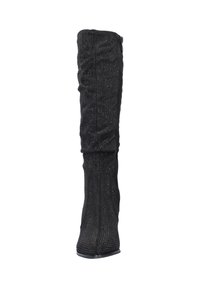 Black over-the-knee boot with a textured fabric and metallic studded accents, featuring a fitted design and a pointed toe. Side zipper closure.