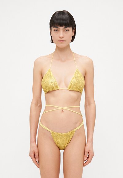 Yellow sequin bikini set featuring a triangle top with thin straps and a low-rise bottom with wrap-around ties, highlighting textured embellishments.