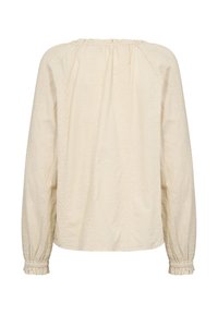 Blouse à manches longues couleur crème avec des détails brodés sur le devant et les poignets, dotée d'un col froncé et d'un tissu texturé doux.