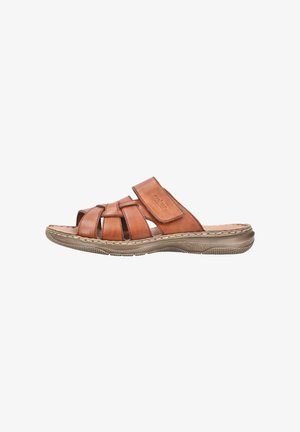 Brown leather slide sandal featuring crisscross straps, open toe, and a textured sole. Soft footbed with contrasting stitching along the edge.