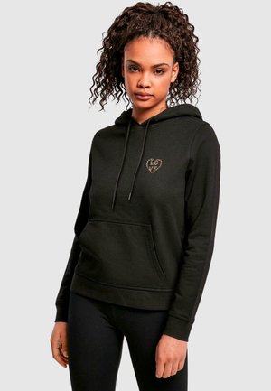 Black hoodie made of cotton blend, featuring a front pocket and lined hood. Notable heart-shaped design in gold on the chest area.