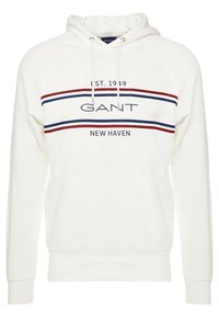 Felpa bianca con tasca a marsupio. Caratterizzata da righe orizzontali rosse e blu navy e dal logo "GANT". Tessuto misto cotone con cappuccio regolabile.