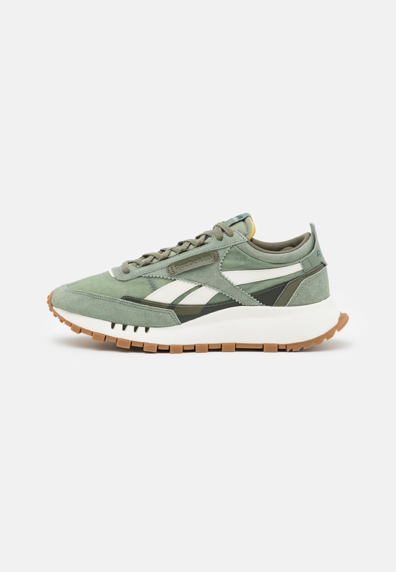Light green sneaker featuring a suede and mesh upper, white accents, a thick white sole, and a rubberized brown outsole.