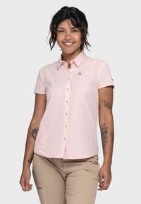 Light pink short-sleeved shirt with a button-up front, collar, and a small logo on the chest. Smooth fabric with a fitted design.