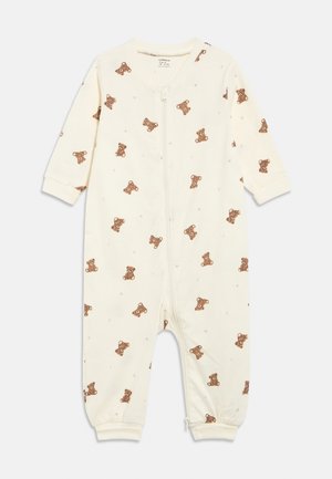 Flødefarvet babybody med print af brun teddybjørn, stjerne og halvmåne, lange ærmer og lynlåslukning foran.