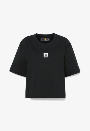 Sort bomulds t-shirt med korte ærmer, rund halsudskæring og et firkantet hvidt Timberland-logo på forsiden. Glat tekstur.