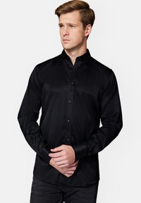 Czarna koszula z długim rękawem zapinana na guziki, wykonana z gładkiej tkaniny; ma klasyczny kołnierzyk i zapinany na guziki przód z dopasowanymi guzikami.