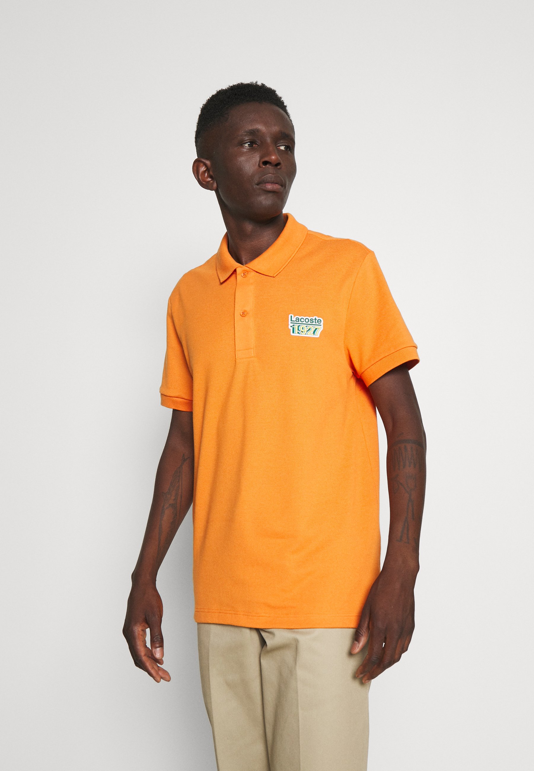 orange lacoste polo shirt