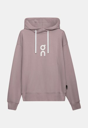 Kapuci džemperis mīkstā mauves krāsā ar baltām auklām un logotipu. Raksturots ar brīvu piegriezumu, garām piedurknēm un ribota materiāla apakšmalu. Gluda tekstūra.