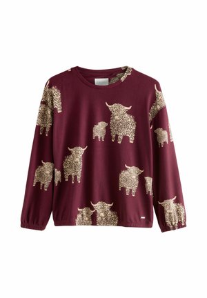 Burgundijas krāsas garas piedurknes džemperis ar atkārtotu gaiši bežīgu pūkainu govju rakstu, kurā ir teksturēti akcenti uz auduma.