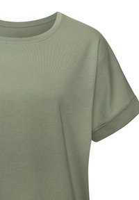 Olive green cotton t-shirt with a rounded neckline and rolled short sleeves. Features a smooth texture and casual fit.